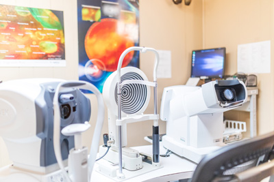 Optometry exam room with diagnostic equipment.